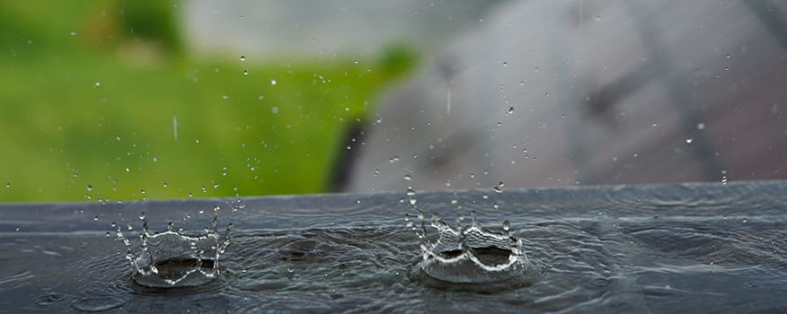 Rain,Droplets,Splashing,On,Flat,Window,Ledge roof coatings for commercial buildings in kearney